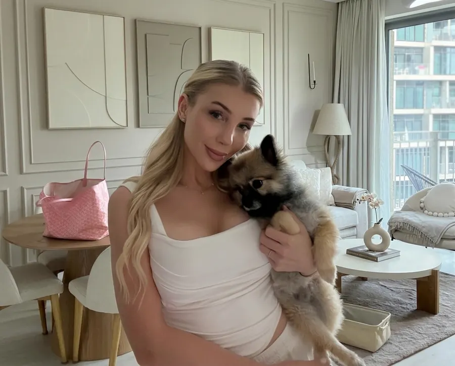 Furs Class Travel founder Kristey holding her Pomeranian Kio after UK → UAE travel
